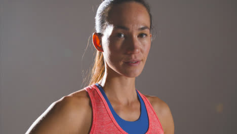 Close-Up-Shot-of-Young-Woman-Looking-at-Camera-at-Gym