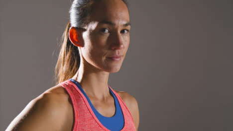 Close-Up-Shot-of-a-Young-Woman-Looking-at-Camera-at-Gym