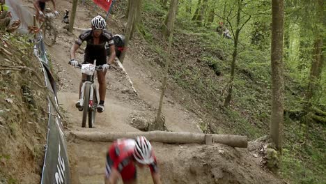 Racing-bicyclists-jump-over-an-obstacle-in-the-path