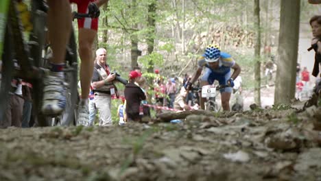 Bicycle-racers-pass-by-a-waiting-crowd