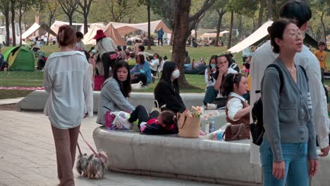 Happy-Chinese-netizens-with-kids-enjoying-outdoor-picnic-in-urban-downtown-park-on-a-weekend-afternoon