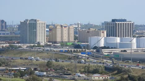 Airplane-departing-from-Pearson-airport,-people-commuting-on-the-highway