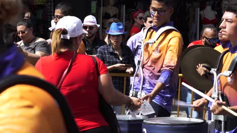 Marching-Band-Drummer-Being-Given-Water-For-Hydration-During-Costa-Rican-Independence-Day-Parade