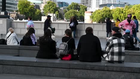 Friends-sitting-around-The-Scoop,-London,-United-Kingdom