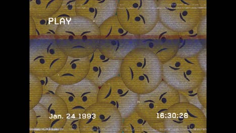 Digital-animation-of-vhs-glitch-effect-over-multiple-angry-face-emojis-on-black-background