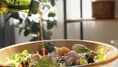 Adding-Olive-Oil-to-Salad-in-Bowl