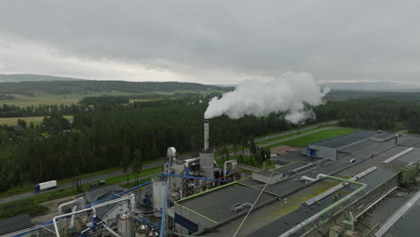 Smokestack-Releasing-White-Steam-From-Industrial-Wood-Manufacturing-Plant-In-Norway