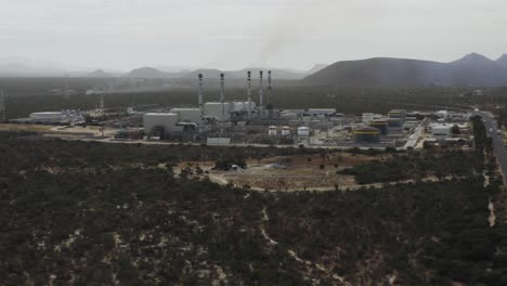Drone-shot-rising-over-a-gas-fired-power-station-in-a-desert-in-Mexico